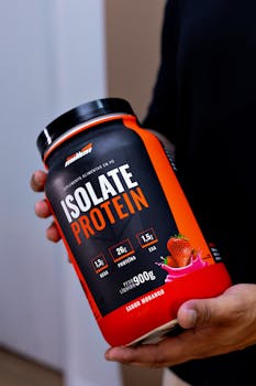 Variety of protein powder containers including whey, casein, and plant-based options displayed on a kitchen counter, representing different choices for muscle gain.