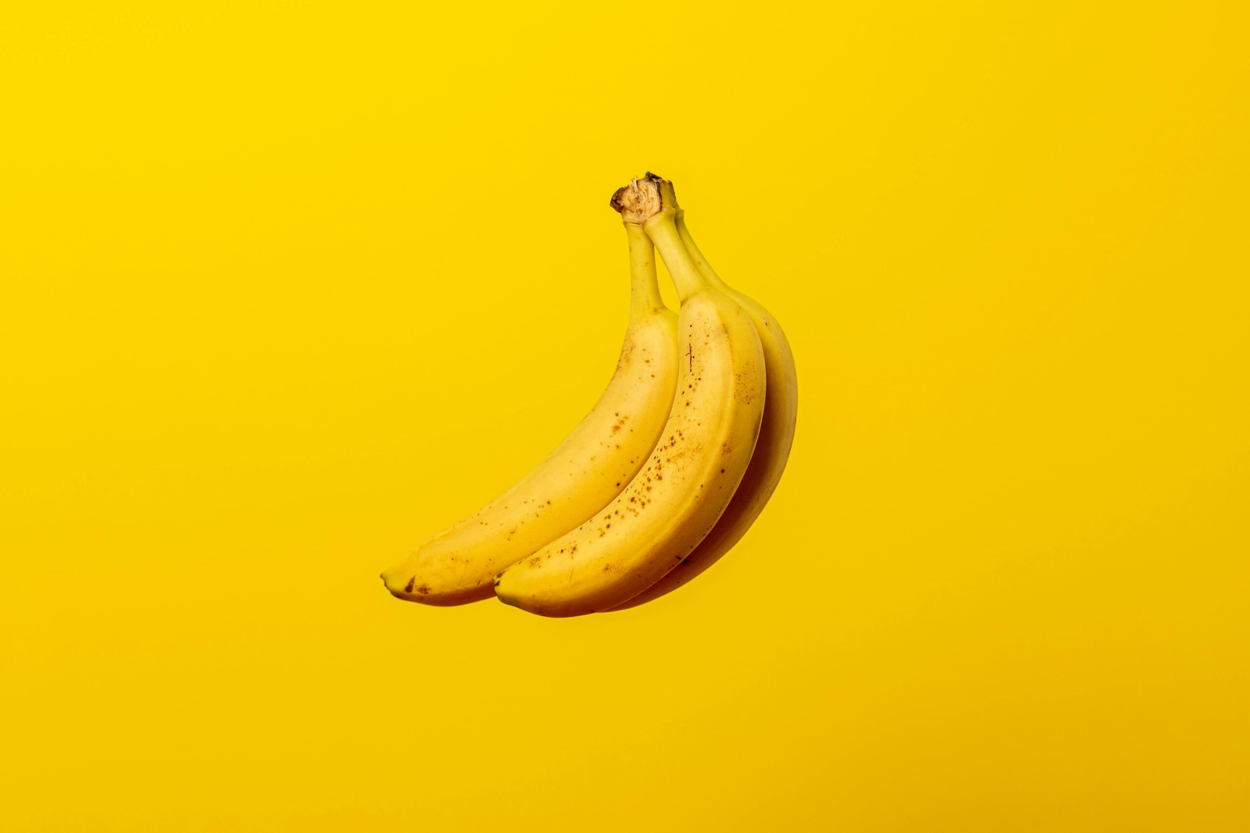 High-quality image showing ripe bananas on a clean background, emphasizing their nutritional value of banana
